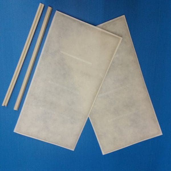 Two Breathe Easy – Diffuser Air Filters and three beige sticks rest on a blue surface.